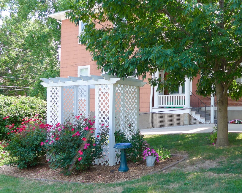 King's Daughters and Sons Home Backyard with trellis and rosebushes